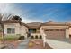 Charming single-story home featuring a tile roof, desert landscaping, and a two-car garage at 85 Alerion St, Las Vegas, NV 89138