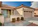 Beautiful home with a tile roof, two-car garage, well maintained landscaping, and secure front gate at 85 Alerion St, Las Vegas, NV 89138