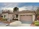 Attractive home with a tile roof, two-car garage, and manicured landscaping in a desirable neighborhood at 85 Alerion St, Las Vegas, NV 89138