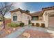 Single story home featuring desert landscaping, a quaint gated courtyard and a tile roof at 85 Alerion St, Las Vegas, NV 89138