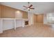 Open living room featuring a fireplace, large tile flooring, and a modern ceiling fan at 85 Alerion St, Las Vegas, NV 89138