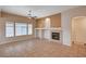 Bright living room features a cozy fireplace, large windows, and open space for relaxation and entertaining guests at 85 Alerion St, Las Vegas, NV 89138