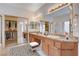 Bathroom with double vanity sinks, granite counters, large mirrors, and walk-in closet at 85 Alerion St, Las Vegas, NV 89138