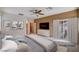 Staged primary bedroom with ceiling fan, neutral colors, and sliding glass doors to the backyard at 85 Alerion St, Las Vegas, NV 89138