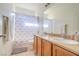 Bright bathroom with double sinks, spacious vanity, neutral finishes, and a shower/tub combo at 8523 Peaceful Dreams St, Las Vegas, NV 89139