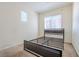 Bedroom with a bed frame and natural light from the windows creating a peaceful atmosphere at 8523 Peaceful Dreams St, Las Vegas, NV 89139