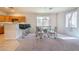 Bright dining area with table, chairs, breakfast bar, and natural light from the window at 8523 Peaceful Dreams St, Las Vegas, NV 89139