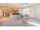 Bright dining area with chairs, breakfast bar and stainless steel refrigerator, and natural light from the window at 8523 Peaceful Dreams St, Las Vegas, NV 89139