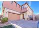 Two-story townhome featuring a large garage and a secure gated entrance at 8523 Peaceful Dreams St, Las Vegas, NV 89139