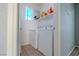 Bright laundry room featuring a washer, dryer, storage shelf, and a window for natural light at 8523 Peaceful Dreams St, Las Vegas, NV 89139