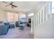 Well-lit living room with a modern ceiling fan and staircase access at 8523 Peaceful Dreams St, Las Vegas, NV 89139