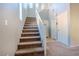 Carpeted staircase with white railing leads to the upper level of the home at 8523 Peaceful Dreams St, Las Vegas, NV 89139