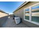 Backyard featuring gravel landscaping, exterior window view, covered AC unit, and perimeter wall at 889 Elmwood Forest Ln, Las Vegas, NV 89138