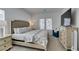 Bright bedroom featuring patterned bedding, large dresser with a TV, and a comfortable armchair at 889 Elmwood Forest Ln, Las Vegas, NV 89138