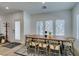 Bright dining area featuring a large table, natural light and entry door at 889 Elmwood Forest Ln, Las Vegas, NV 89138