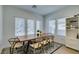 Bright dining area featuring a large table, natural light, and a modern built-in cabinet at 889 Elmwood Forest Ln, Las Vegas, NV 89138