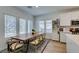 Bright dining area featuring a large table, natural light, and a modern built-in cabinet at 889 Elmwood Forest Ln, Las Vegas, NV 89138