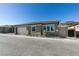 Single-story home featuring a white garage door, a neatly landscaped front yard, and grey-toned exterior at 889 Elmwood Forest Ln, Las Vegas, NV 89138