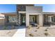 Inviting front exterior featuring a stacked stone accent wall and cozy seating area at 889 Elmwood Forest Ln, Las Vegas, NV 89138