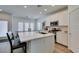 Modern kitchen with an island that includes seating, countertop and sink, plus stainless appliances at 889 Elmwood Forest Ln, Las Vegas, NV 89138