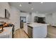 Modern kitchen featuring stainless steel appliances, white cabinets, and a large island with sink at 889 Elmwood Forest Ln, Las Vegas, NV 89138