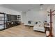 Well-lit living room with a white sofa, entertainment center, and sleek flooring at 889 Elmwood Forest Ln, Las Vegas, NV 89138