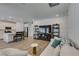 Spacious living area featuring an open-concept kitchen with stainless appliances and modern decor at 889 Elmwood Forest Ln, Las Vegas, NV 89138