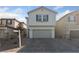 Two-story house with gray siding, two-car garage, and a paved driveway at 9062 Lucky Crest St, Las Vegas, NV 89113