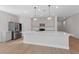 Modern kitchen with light gray cabinets, quartz countertops, and stainless steel appliances at 9062 Lucky Crest St, Las Vegas, NV 89113