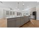 Modern kitchen island with white countertop and gray cabinets at 9062 Lucky Crest St, Las Vegas, NV 89113