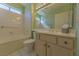 Bright bathroom features double sinks and a shower-tub combination at 9524 Quail Ridge Dr, Las Vegas, NV 89134