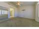 Primary bedroom with carpet flooring, ceiling fan, plantation shutters, and an entrance to the bathroom at 9524 Quail Ridge Dr, Las Vegas, NV 89134