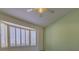 Bedroom showcasing plantation shutters, a ceiling fan, and a view of the backyard at 9524 Quail Ridge Dr, Las Vegas, NV 89134