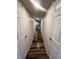 Hallway with wood floors and white doors leading to rooms at , Henderson, NV 89014