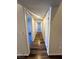 Neutral colored hallway with wood-style flooring and multiple doors at , Henderson, NV 89014