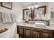 Well-lit bathroom with granite countertop, decorative mirrors, and dark wood cabinetry at , Las Vegas, NV 89109