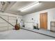 Spacious two car garage featuring painted concrete floors, utility sink, and white cabinets at , Las Vegas, NV 89109