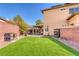 Artificial turf backyard with covered patio and storage at 10212 Cider Mill Rd, Las Vegas, NV 89135