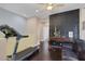 Home gym with treadmill, leather couch and brick feature wall at 10212 Cider Mill Rd, Las Vegas, NV 89135