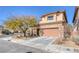 Two-story house with stone accents and a two-car garage at 10212 Cider Mill Rd, Las Vegas, NV 89135