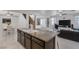 Kitchen island with granite countertops and a view into the living room at 10212 Cider Mill Rd, Las Vegas, NV 89135