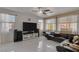 Living room with sectional sofa and large TV at 10212 Cider Mill Rd, Las Vegas, NV 89135