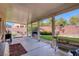 Large covered patio with concrete flooring and grill at 10212 Cider Mill Rd, Las Vegas, NV 89135