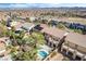 An aerial view of houses with pools, patios, and lush landscaping in a neighborhood at 1163 Highbury Grove St, Henderson, NV 89002