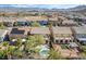 Aerial view of a backyard featuring a refreshing pool, patio, dining area, and lush trees for privacy and beauty at 1163 Highbury Grove St, Henderson, NV 89002