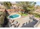 Aerial view of backyard featuring a sparkling pool, seating, and well-manicured landscaping at 1163 Highbury Grove St, Henderson, NV 89002