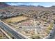 Community aerial view showcasing the recreation areas, desert landscaping, and mountain views at 1163 Highbury Grove St, Henderson, NV 89002