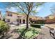 Expansive backyard featuring a pool, well-manicured lawn, and mature trees offering shade at 1163 Highbury Grove St, Henderson, NV 89002