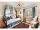 Cozy bedroom with a vintage daybed, patterned rug, and light-filled window at 1163 Highbury Grove St, Henderson, NV 89002