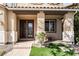 Elegant front entrance featuring double doors, a charming bench, and manicured landscaping at 1163 Highbury Grove St, Henderson, NV 89002